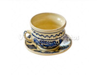 Handpainted cup and saucer isolated on white