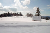 Winter landscape with a small cottage